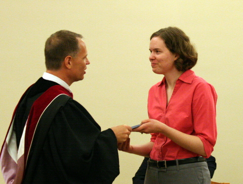 President Jay Rundell presents graduating senior Meredith McDougle with the C. Everett and Mary Milburn Tilson Social Justice Grant